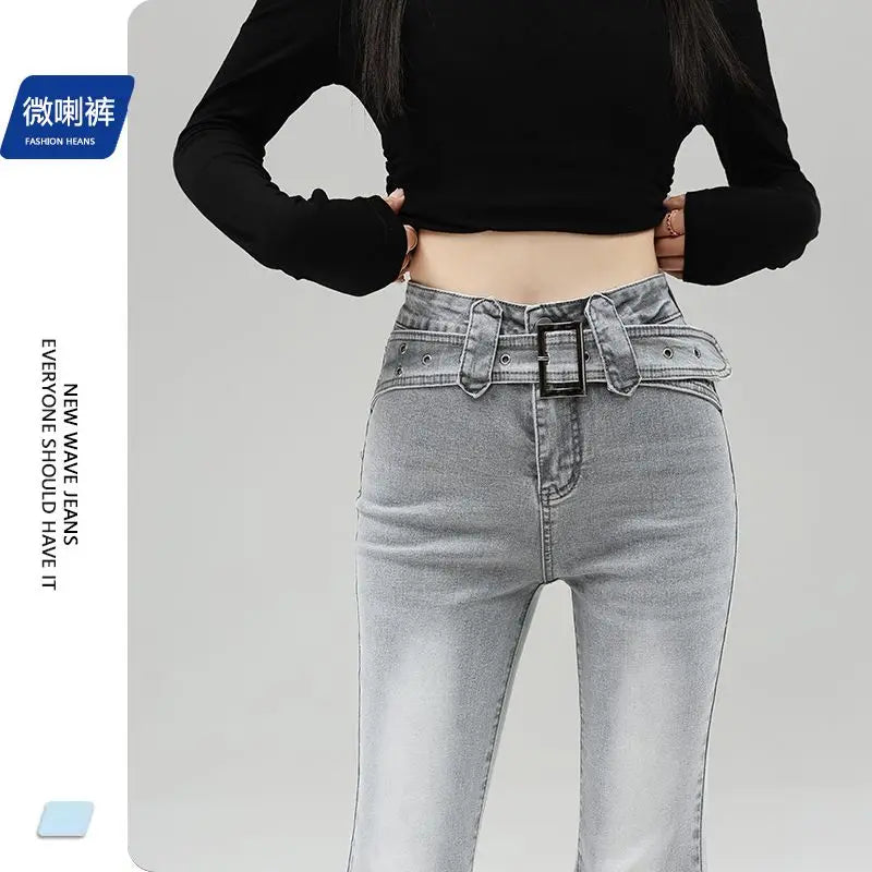 Light gray denim slightly flared pants for women with a distinctive belt, casual trendy fashion